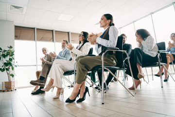 Team collaboration during a professional workplace seminar showcasing teamwork among diverse employees in a modern office setting