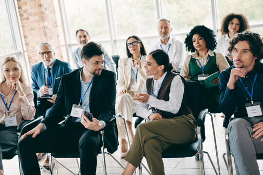 Corporate professionals collaborating in a business meeting discussing new strategies and teamwork ideas in a modern office setup - Powered by Adobe