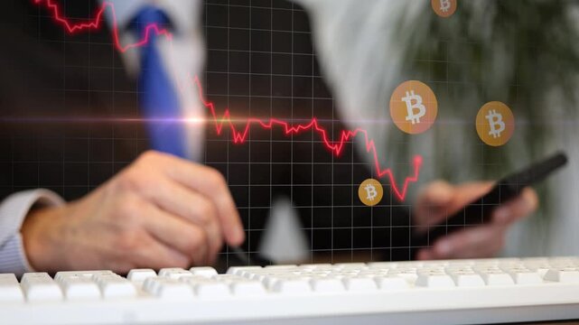 Animation of a businessman at his keyboard selling with smartphone app cryptocurrency while a digital red line graph and Bitcoin icons plunge downward, representing a market drop financial instability