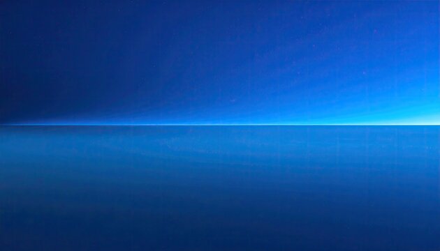 Horizon line dividing deep blue sky and calm ocean surface