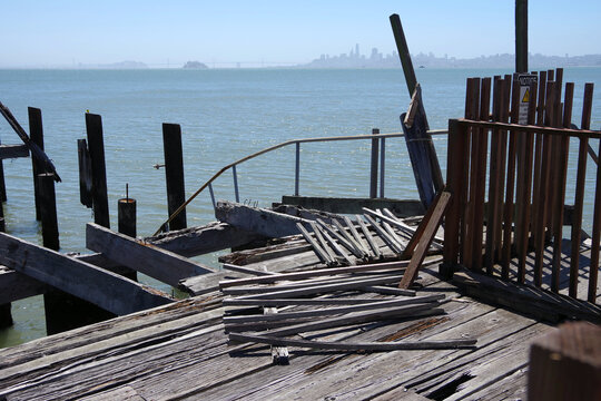 Old dilapidated wooden pier in Tiburon with San Francisco in the distant background