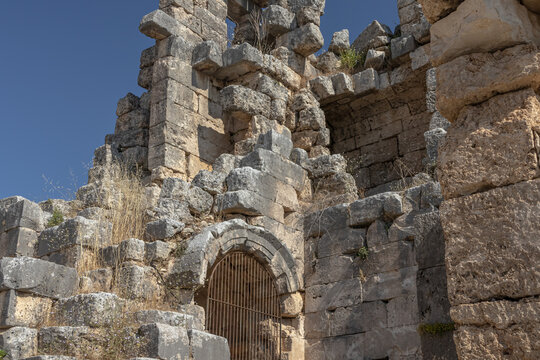 Ruins of the amphitheater in the city of Perge. An ancient city located in Turkey. The walls of the amphitheater in the ancient city are made of huge stone blocks. Masonry of ancient buildings.