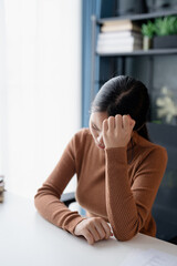 Stressed Asian Businesswoman Burnout tired with headache in office