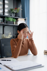 Stressed Asian Businesswoman Burnout tired with headache in office