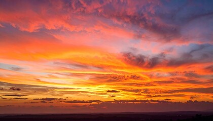 Obraz premium Vibrant sunset sky ablaze with fiery orange, red, and yellow hues