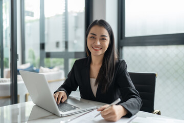 Beautiful&nbsp;confident asian business woman working with laptop Hands typing  keyboard. Professional investor working new start up project. business planning in office. Technology business