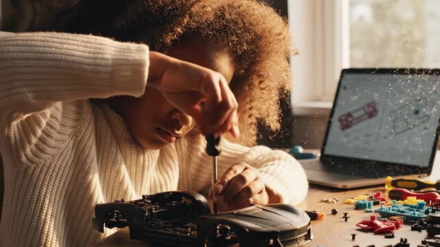 Woman repairs hard drive using screwdriver at home desk. Technician fixes computer hardware with tools. Woman working on drive repair. Hardware technician uses screwdriver for computer repair.