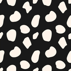 Simple vector seamless pattern with chaotic spots, dots, randomly scattered shapes. Black and white terrazzo flooring texture. Stylized animal skin print. Monochrome abstract background. Repeat design
