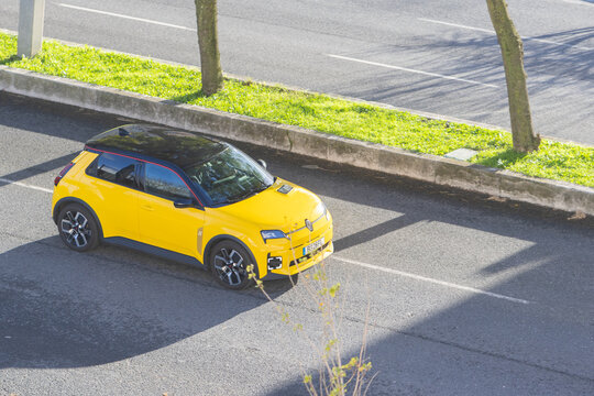 Renault 5 e tech electric car driving on city street