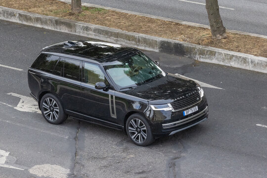 Black range rover luxury suv driving on city street