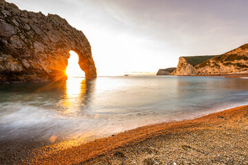 Durdle Door sea arch at sunset Dorset England