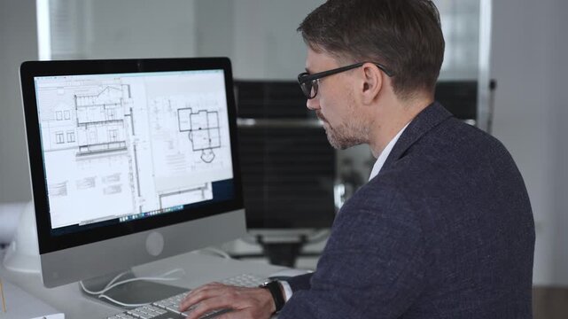 Architect developing building blueprint on computer, engineering and urban planning a new construction project. Business and architecture concept