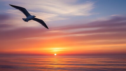 Naklejka premium Seagull soaring over ocean at sunset with dramatic colorful sky and calm waters creating peaceful seascape scene for travel and nature concepts.