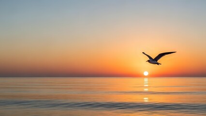 Fototapeta premium Seagull flying over calm ocean waters during golden sunset with warm orange and pink sky colors reflecting on water surface creating peaceful seascape scene.