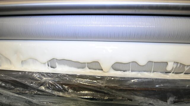 The process of laminating sheets in a printing house. A machine for applying glue to sheets in the production shop of a printing house