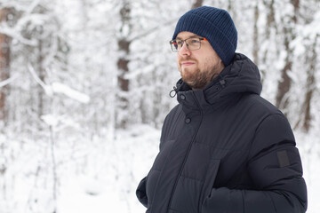 Portrait of a man in a snowy forest.