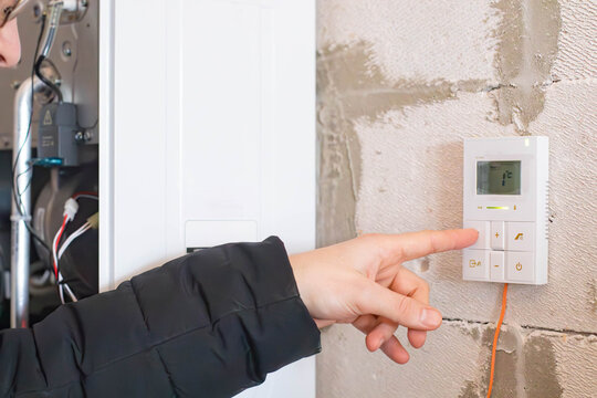 A man checks the operation of a gas boiler.