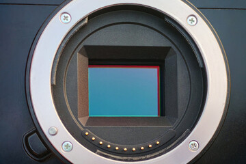 Close up shot of APS-C (Crop Sensor) CMOS sensor in mirrorless camera with metallic mount and lens contact points