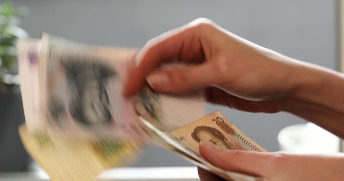 Woman counts chinese yuan banknotes. Cash transaction and financial exchange. Investment and budget concept for income or payment.