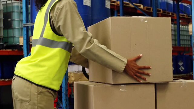 worker in warehouse carries mail carton product boxes