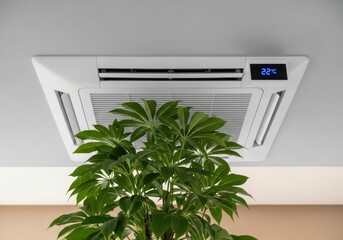 Modern Ceiling Mounted Air Conditioner with Digital Display Above a Lush Green Plant.