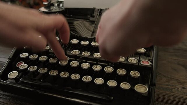 Woman hands typing on keyboard with fingers vintage typewriter close up