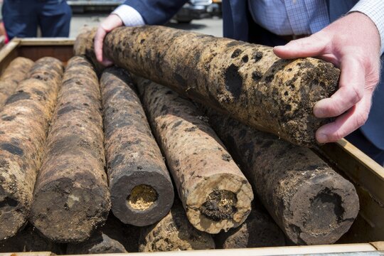 Marine Sediment Core Sections Being Analyzed and Arranged by a Geological Expert