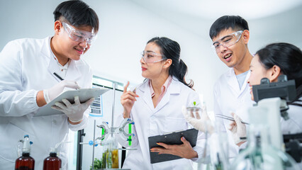 Fototapeta premium Team of scientists collaborating on algae and plant-based bioenergy research in laboratory, representing renewable energy testing clean technology innovation, sustainability, and ESG-focused corporate