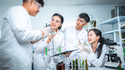 Fototapeta premium Team of scientists collaborating on algae and plant-based bioenergy research in laboratory, representing renewable energy testing clean technology innovation, sustainability, and ESG-focused corporate