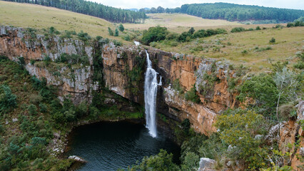 Witness the stunning Berlin waterfall flowing gracefully into a tranquil pool surrounded by lush...