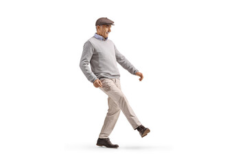 Senior man trying to kick something with his leg