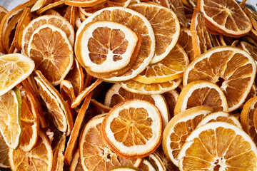 Dried orange slices and citrus peels, a vibrant and textured background