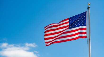 Obraz premium An American flag proudly waving on a tall pole against a bright blue sky, embodying the spirit of freedom and unity for an Independence Day USA concept