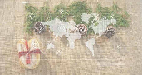 Fototapete Kekse Displaying white world map overlay on burlap, with conifer sprigs, pinecones, ribboned heart-cookie  © vectorfusionart