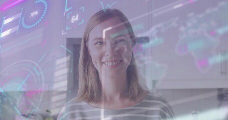 Standing mid-adult woman smiling and viewing holographic HUD overlays in home kitchen, striped top