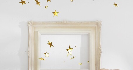 Displaying cream frame revealing white mat on white wall at home, with gold stars, beige cushion