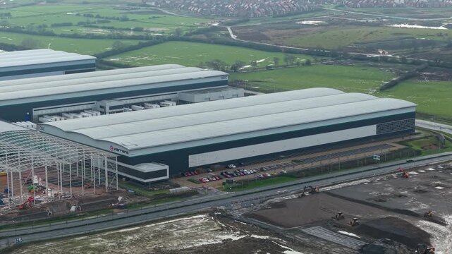 Northampton, United Kingdom - 17 January 2026: Aerial view of the vast Royal Mail Midlands Super Hub, contrasting with the surrounding green fields.