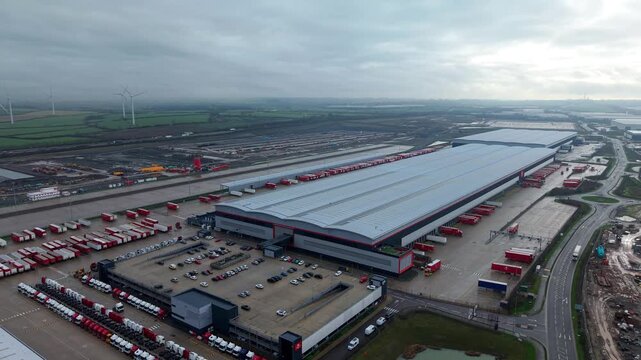Northampton, United Kingdom - 17 January 2026: Aerial view of the Royal Mail Midlands Super Hub, a vast distribution center with rows of delivery trucks.