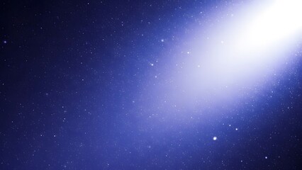 Obraz premium A bright light shining in a starry night sky with a blue hue