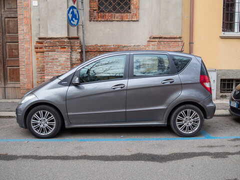 Mercedes Benz A Class W169 hatchback and Lancia Ypsilon 2011 city car parked on urban street with blue lines