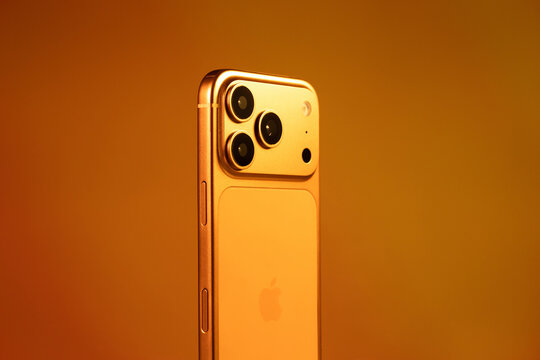 KYIV, UKRAINE - January 22, 2026 : Apple iPhone 17 Pro in Cosmic Orange color on orange background. Back panel with cameras.