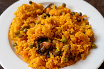 Plate with seafood paella on table in restaurant Andalusia Spain