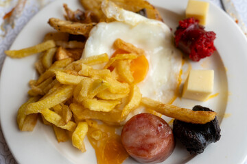Mixed plate with Spanish homemade pork sausages egg and fries