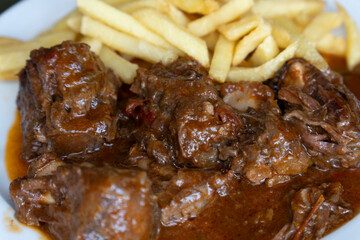 Chicken liver stew in sauce with fried potatoes, typical of Huelva, Andalusia, Spain