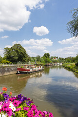 Fototapeta premium Senic view of river and a traditional small freighter in East Flanders in Belgium