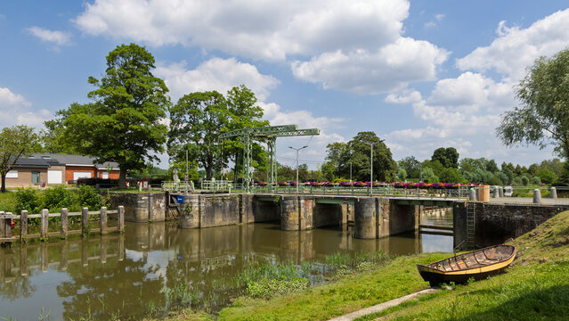 Senic view of drawbridge, river and old rowing boat in East Flanders in Belgium