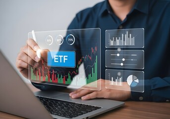 Fototapeta premium Person analyzing etf data on a transparent screen with laptop in front of them in a blue shirt