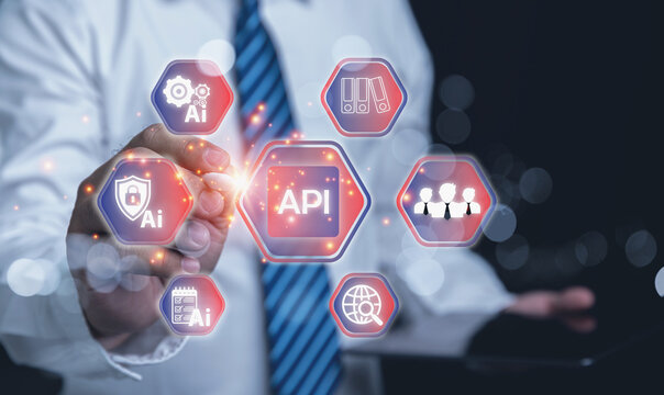 Businessman touching a virtual screen on a polygon with API Application Programming Interface.