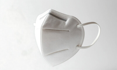 shot worn mask stark white background suspended air soft natural light casting subtle shadows