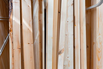 Piles of wooden planks stacked in a warehouse for construction projects in a city setting